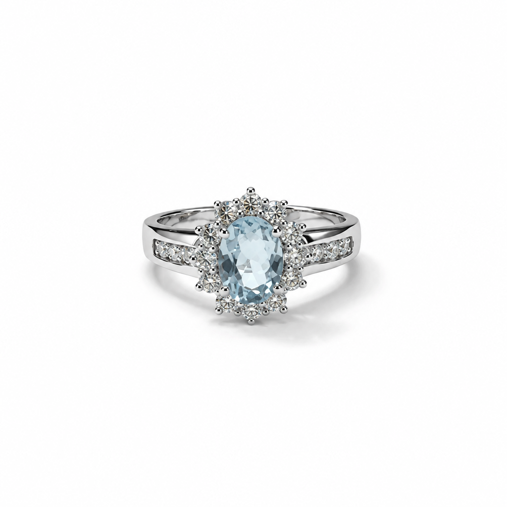 Anello in argento 925 con pietra ovale azzurra, contorno di pietre chiare e dettagli luminosi sul gambo, vista frontale.