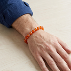 Bracciale in acciaio e corniola indossato su polso maschile
